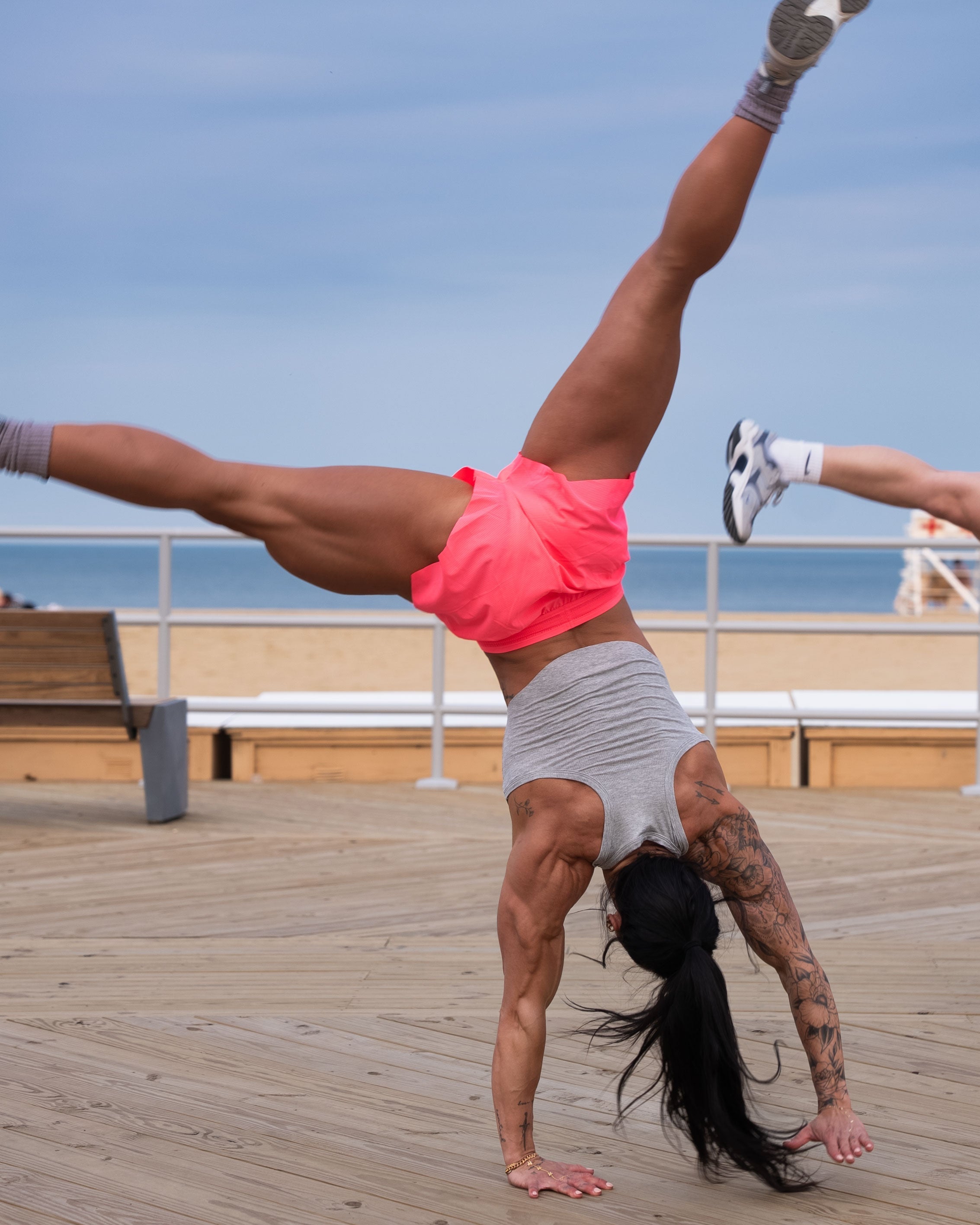 A girl doing a cartwheel on the boardwalk