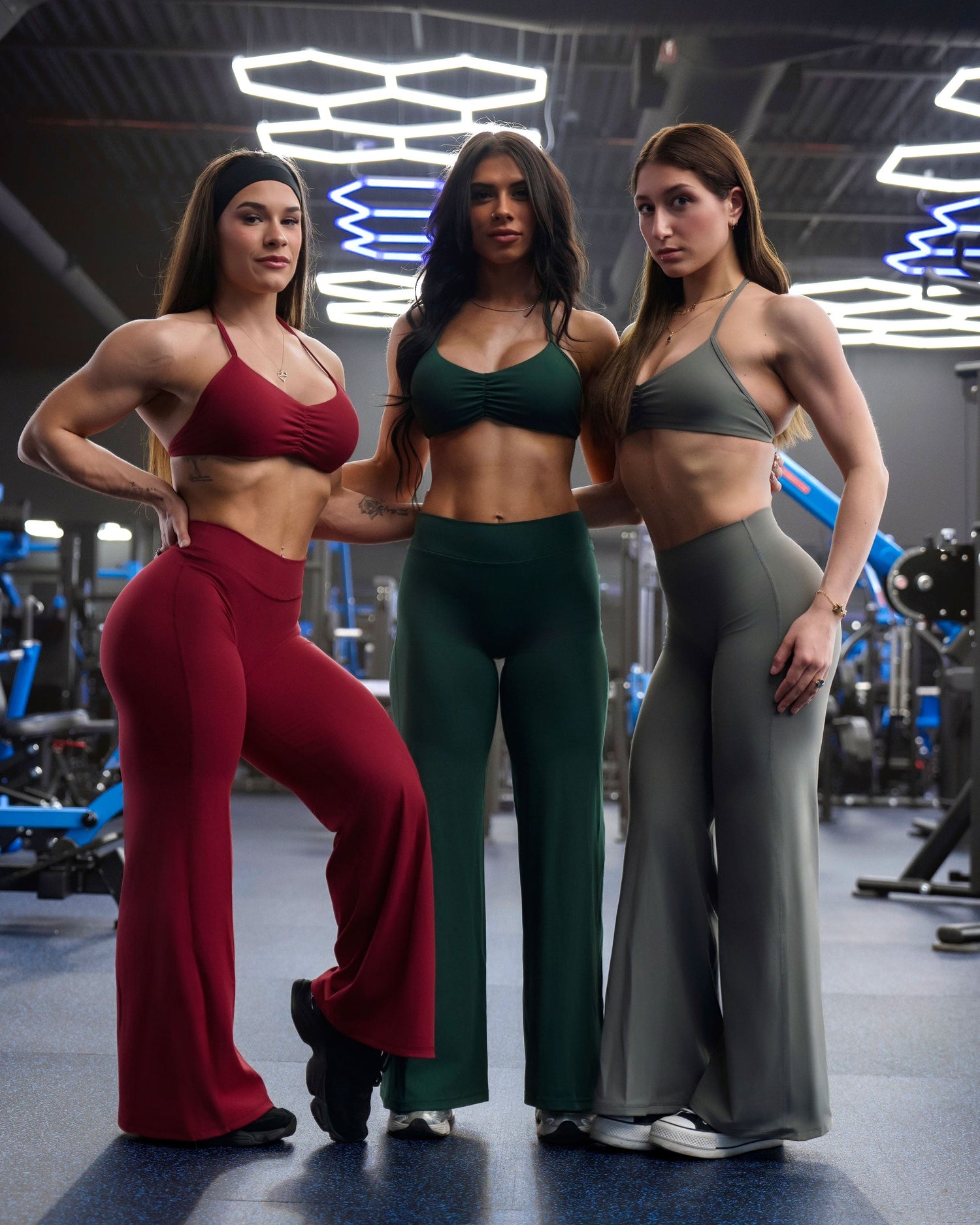 Three girls wearing Violate's Flare collection in the gym.