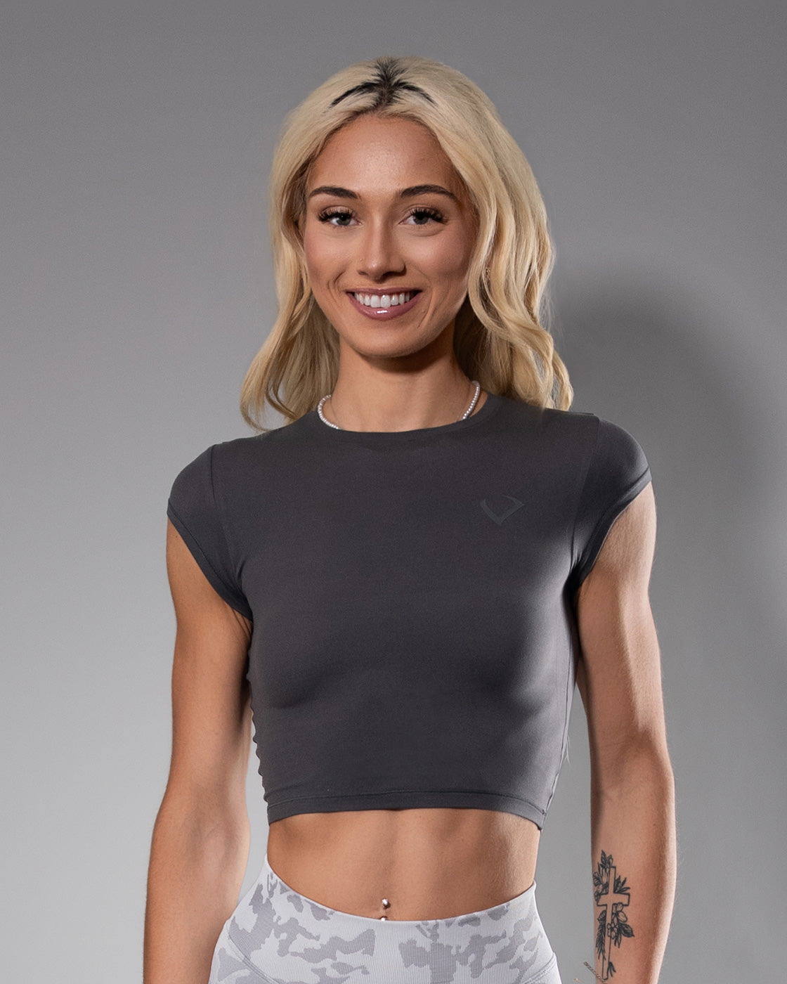 Model wearing a gray tease crop top form Violate the Dress Code