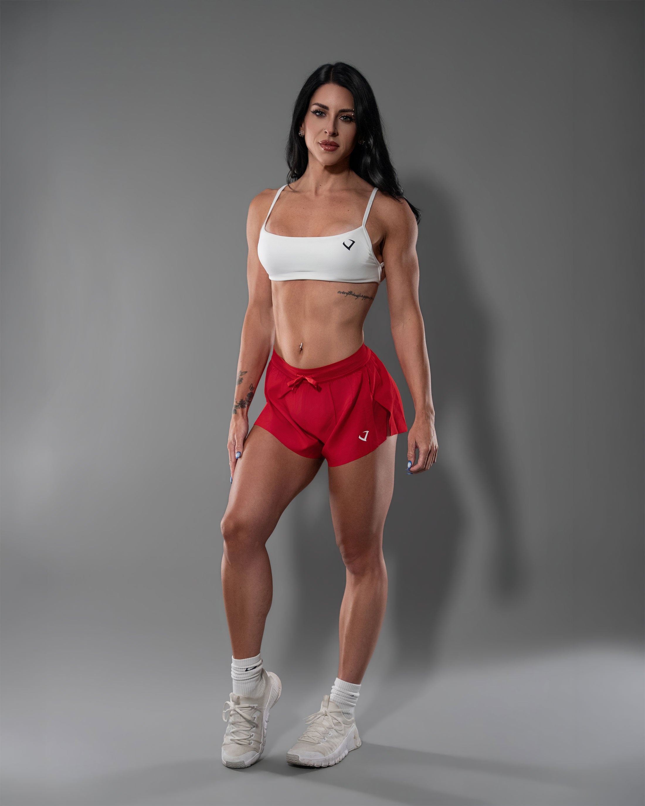 Model in lightweight red Gym Crush Shorts with a high-slit, fly-away fit