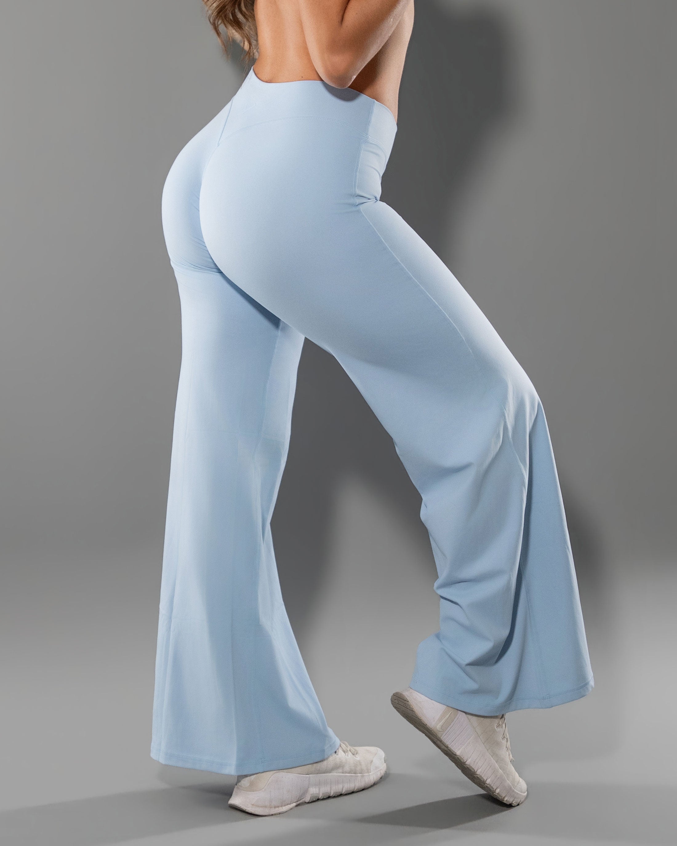Close back view of the Tempt Flares in Sky Blue showing glute contouring seam placement