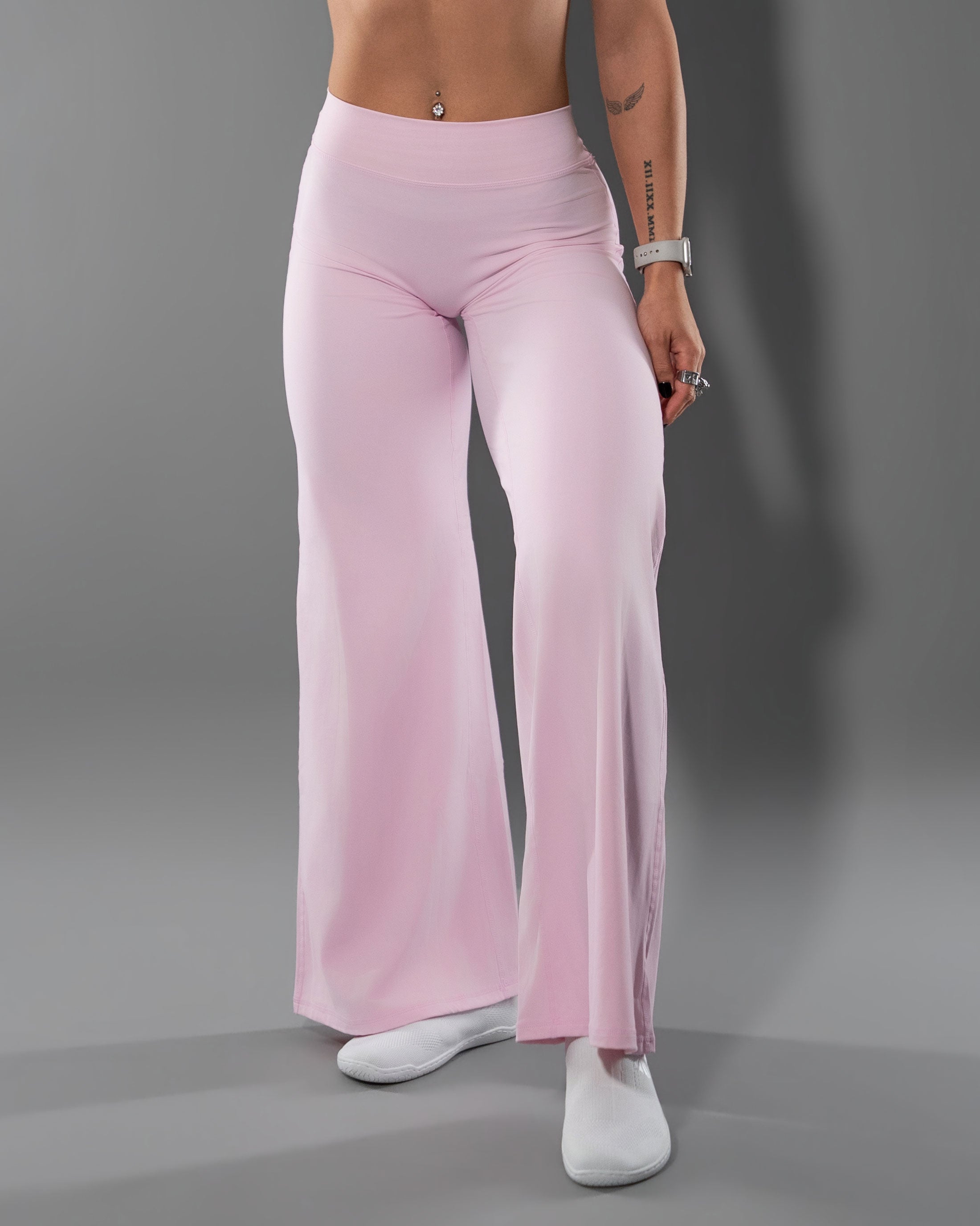 Model wearing the Tempt Flares in Soft Pink with a matching halter top, front view