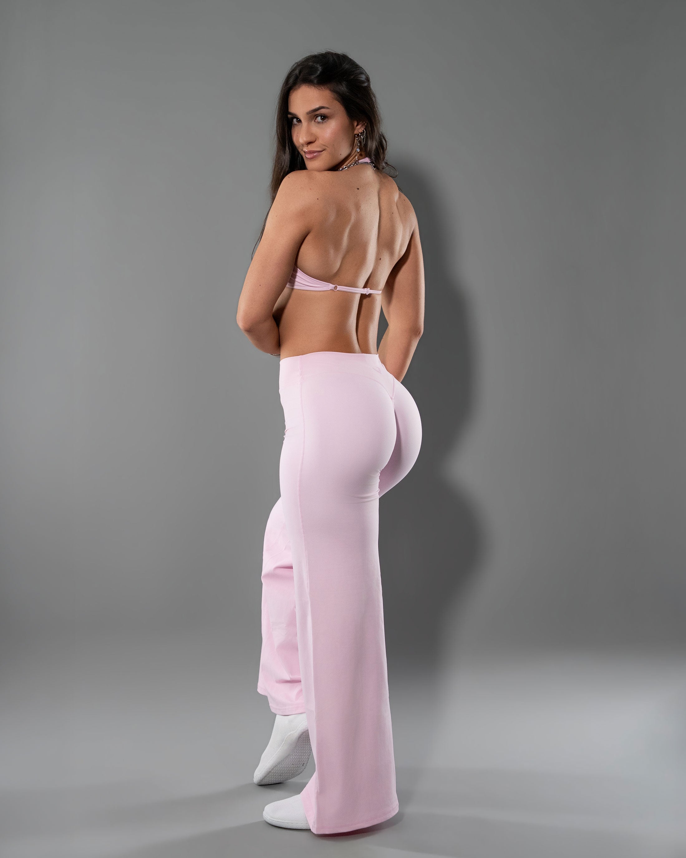 Back view of the Soft Pink Tempt set, flare leggings with open back halter top