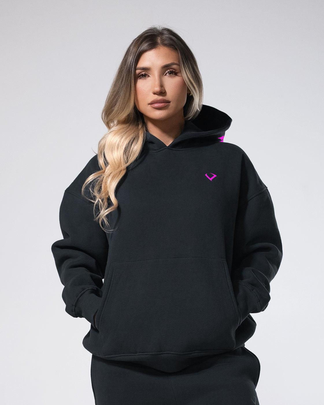 Photo of a woman wearing the black Royalty Skull Hoodie.